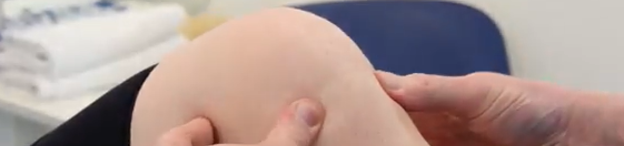 Physio holding patients knee