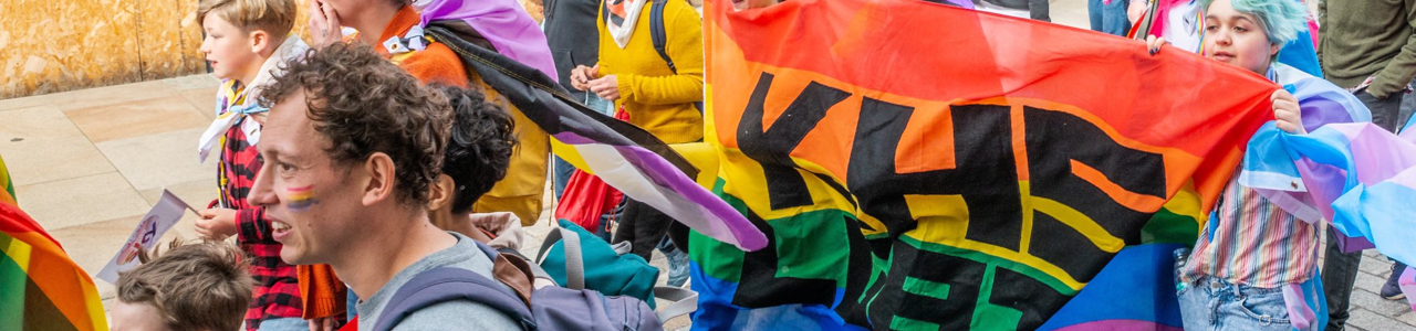 Fife pride parade people holding flag