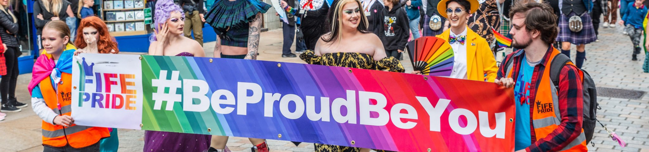 Fife pride parade people holding banner