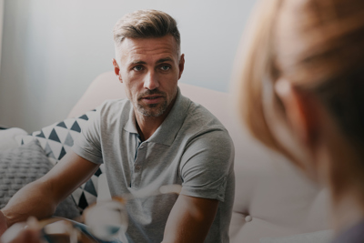 man speaking with woman in counselling