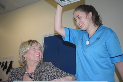 Nurse standing above patient in xray