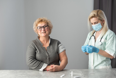 doctor getting jag ready for happy older patient