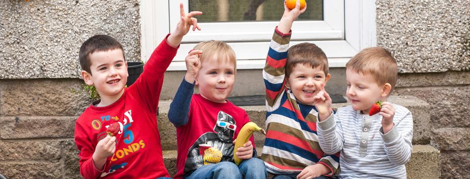 Four Children Eating Fruit