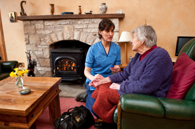 Nurse Visits Older Woman At Home