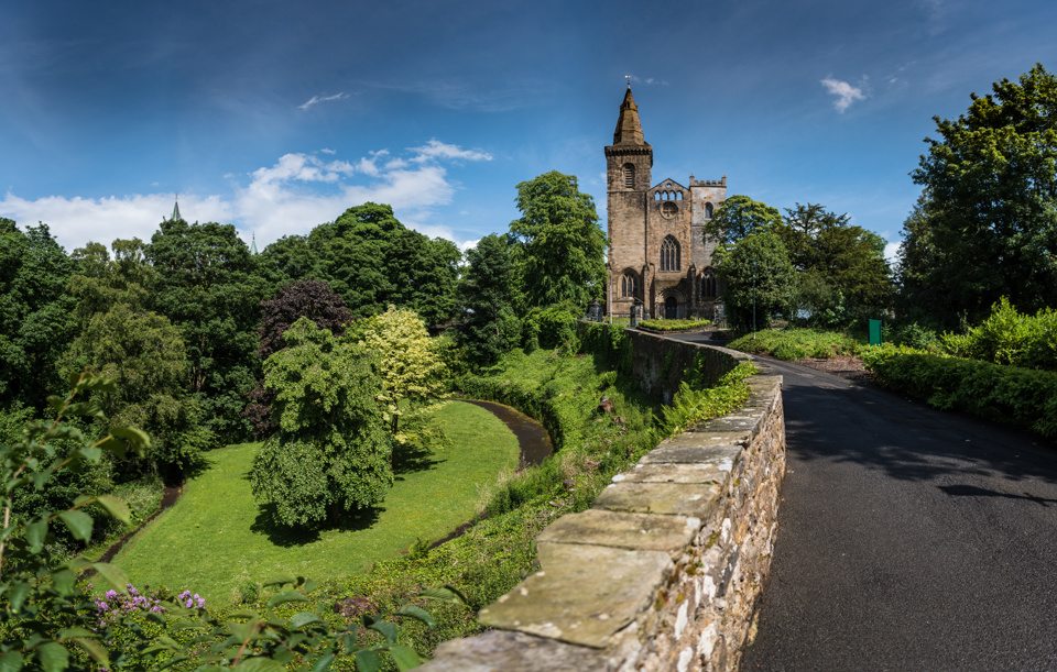 green scenery with abbey in distance