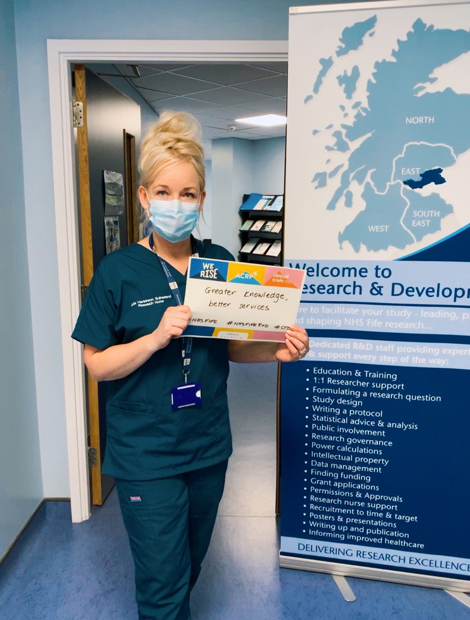 Research nurse holding sign