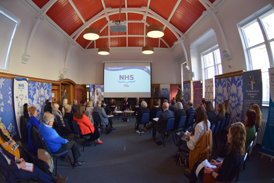 Rows of people in front of NHS presentation